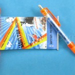 Novelty pens with springloaded banners